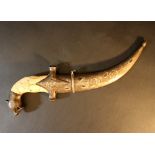 A Persian dagger, in S shape, with lion head grip end, bone grip and richly floral decorated