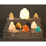 A miniature Buddha altar with eight Buddha statues made of ivory, jade and stones, in different