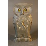 A moving eyes clock in shape of a sitting owl, wood carved with arabic numbers, dial and two