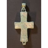 Byzantine reliquary cross with hanging eye and engraved Christus and Cross decorations, with space