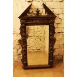 A French Renaissance mirror, walnut with rich ornamental and figural carvings partly gilded,