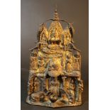 An Asian bronze shrine with Buddha and guards, a monkey and elephant, and several decorations;