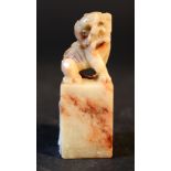 Chinese jade figure of Fo Lion on rectangular base; grey jade with red inclusions.6cm height