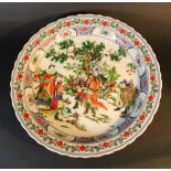 Chinese porcelain dish with family scene and decoration, waved border on white ground; glazed; the