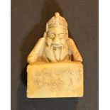 A beige jade item with portrait of a Chinese honorable on base.4cm