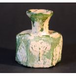 A moulded green glass bottle; in hexagonal shape; with long neck and Jewish symbols of the Menorah