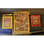 Lot of three Indochinese tangkas; two smaller and one larger; painted on paper and textile; laid