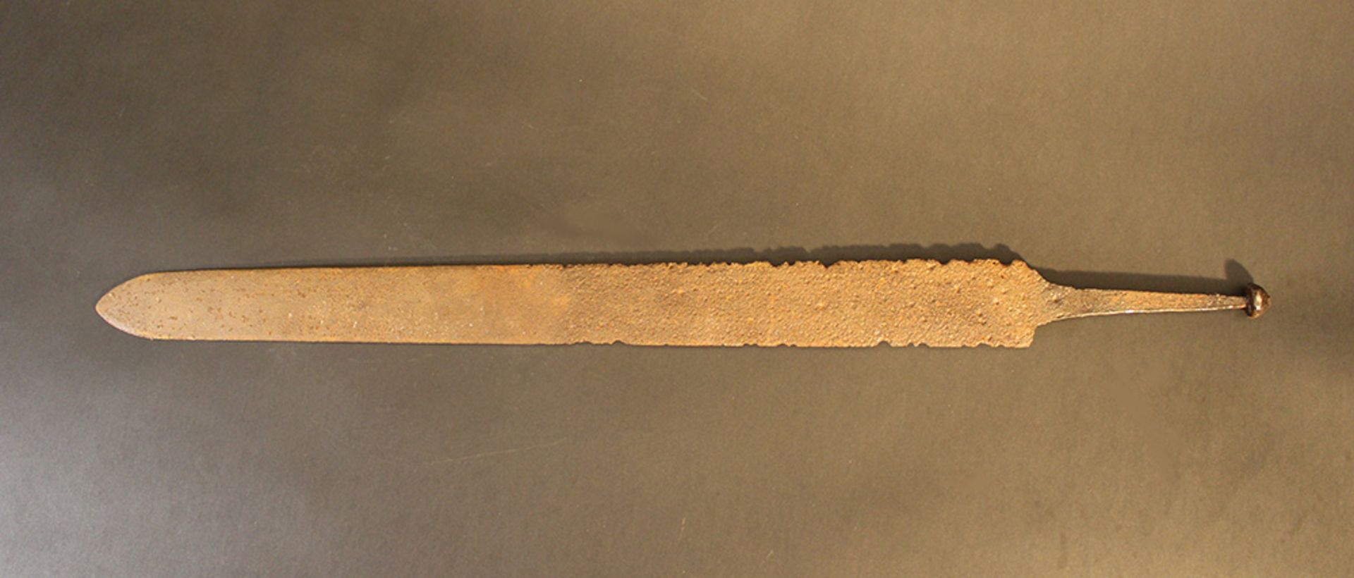A possible Celtic small iron sword with restored blade, hand grip part; rusty; possible earth