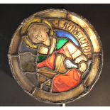 A hand-painted glass window in medieval manner, round shape with pewter section and frame, different
