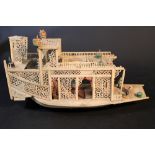 Chinese ivory model of concubine junk, with open work, decorations, figures and script signs;