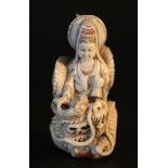 Ivory Netsuke showing Guanyin on a dragon; very fine carving; partly engraved and coloured; with