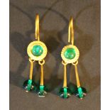 A pair of gold earrings, each with three green glass bowls; partly engraved, with eyes and hanging