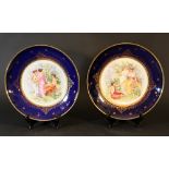 Pair of Vienna porcelain dishes with figural decorations in the centre and painted gild ornaments on