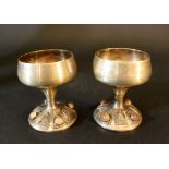 Two silver bakers on round feet with glass stone and thread decorations, a pair, early 20th Century;