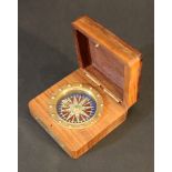 A small compass with directions, in wooden casket, with star intarsia on top, bronze lable described