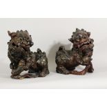 A pair of Chinese wooden Fo Lions, richly sculpted and carved, inside hollow, each with thre lids