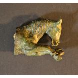Bronze sculpture of the forepart of a running horse, with verdigris and green patina; on the reverse