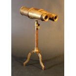 Bronze binoculars with adjustable lenses on bronze stand adjustable in hight; on three legs,