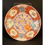 Imari porcelain dish, painted with flowers, ornaments and landscapes; on white ground, glazed; on