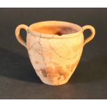 A small terracotta vessel with two hand grips; possibly Roman.height 9cm