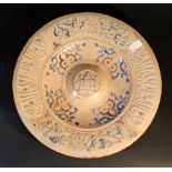 A hispano-moresque ceramic dish in 15th/16th Century manner, with wide border, decorated with