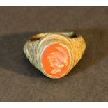 A bronze ring in Ancient style with jasper gemstone showing Minerva's head; bronze with verdigris
