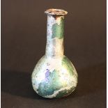 A cosmetic vessel; green glass, round bowed body, with long neck and extended border rim; possibly