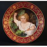 Vienna porcelain dish with painted central portrait of a boy surrounded by grapes; classical