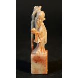 Chinese jade figure of a wise man on rectangular base; grey jade with pink inclusions.9,5cm height