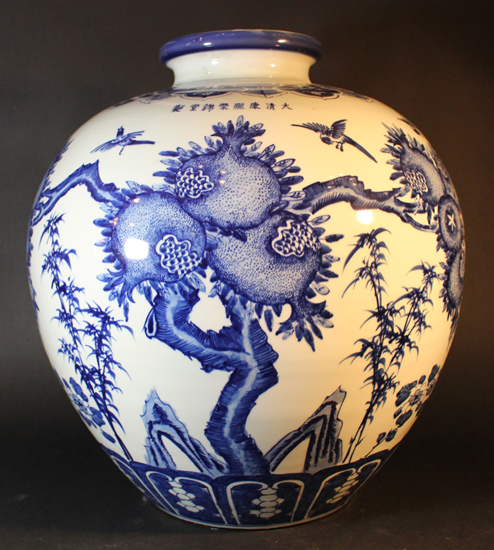 A large Chinese baluster vase with small neck and blue painted pomegranates and leaves on white