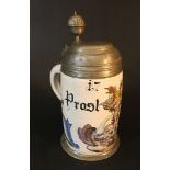 A German ceramic tankard with pewter lid and stand, painted with coat of arms and described „Prost