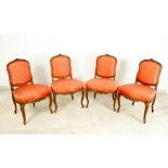 Four elegant baroque style chairs in curved shape with long feet and richly carved flower