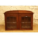 A Jugendstil display cabinett with two doors and arched top, stepped borders, oak and pinewood, with