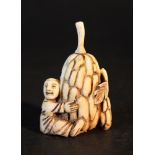 Asian ivory Netsuke of a man holding a fruit with leaves; on the reverse signature and two holes for