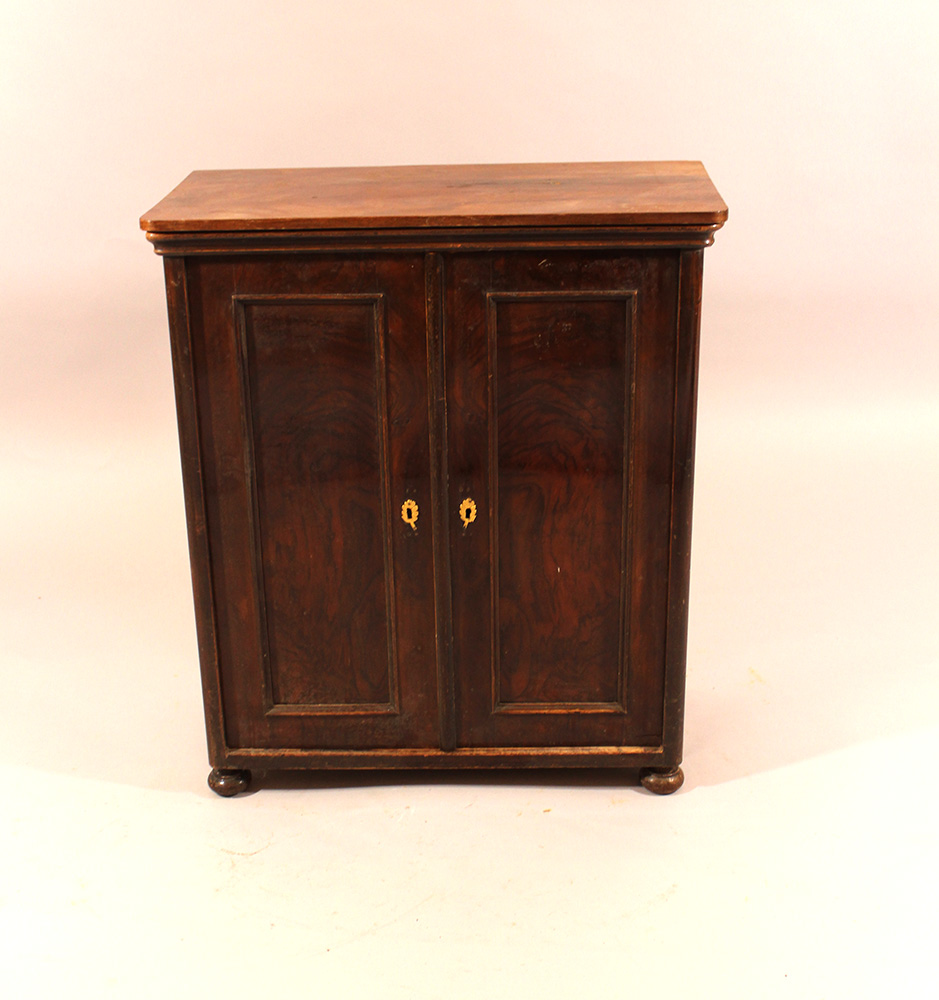 A puppet or miniature armoire with two doors and four turned legs; walnut on pinewood; inside four