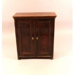 A puppet or miniature armoire with two doors and four turned legs; walnut on pinewood; inside four