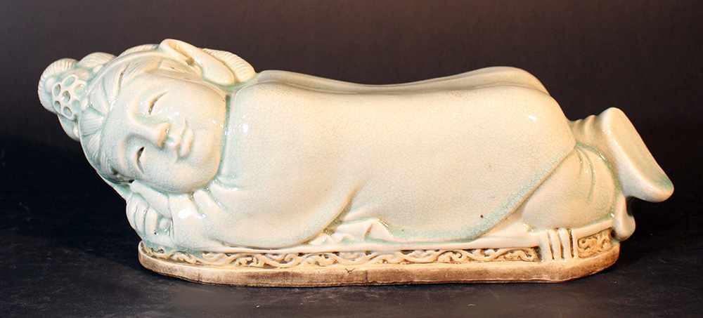 Chinese porcelain head rest, white porcelain with Seladon glaze; in form of a sleeping girl with