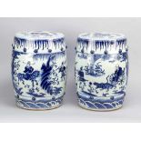 A pair of Chinese porcelain garden seats, painted in blue and white, round shape with several