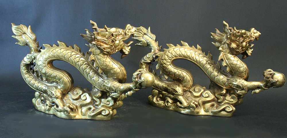 Pair of Chinese bronze gilded dragons, standing in a basis and stretching the right claw with a - Image 2 of 3