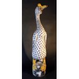 Chinese wooden sculpture of a big standing duck; painted with multicolours; staying on a rock;