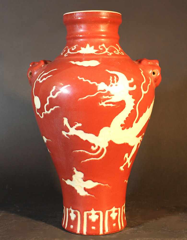 Chinese porcelain Baluster vase with red ground and white dragon, glazed; stepped neck; two hand