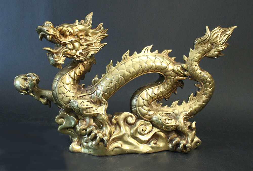 Pair of Chinese bronze gilded dragons, standing in a basis and stretching the right claw with a - Image 3 of 3