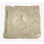 A Roman stone relief, quadratic plinth with sculpted central portrait of a man with stretched