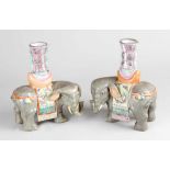 Two oriental porcelain elephants each with one candle holder, naturalistically formed with