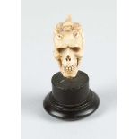 A Memento Mori in Manieristic manner of a skull with scorpion on top; very fine carving on bone,