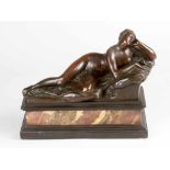 European bronze sculpture of a sleeping and lying female nude, supporting her left arm on a polster,