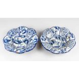 A pair of Delft ceramic dishes, round waved shape with eight border panels painted with blue flowers