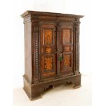 A Tyrolian wardrobe with two doors and three pilasters on a high wooden sawed and shaped base and