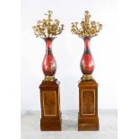 A pair of large hall candelabras on wooden column stands with walnut on pinewood verneered, carved