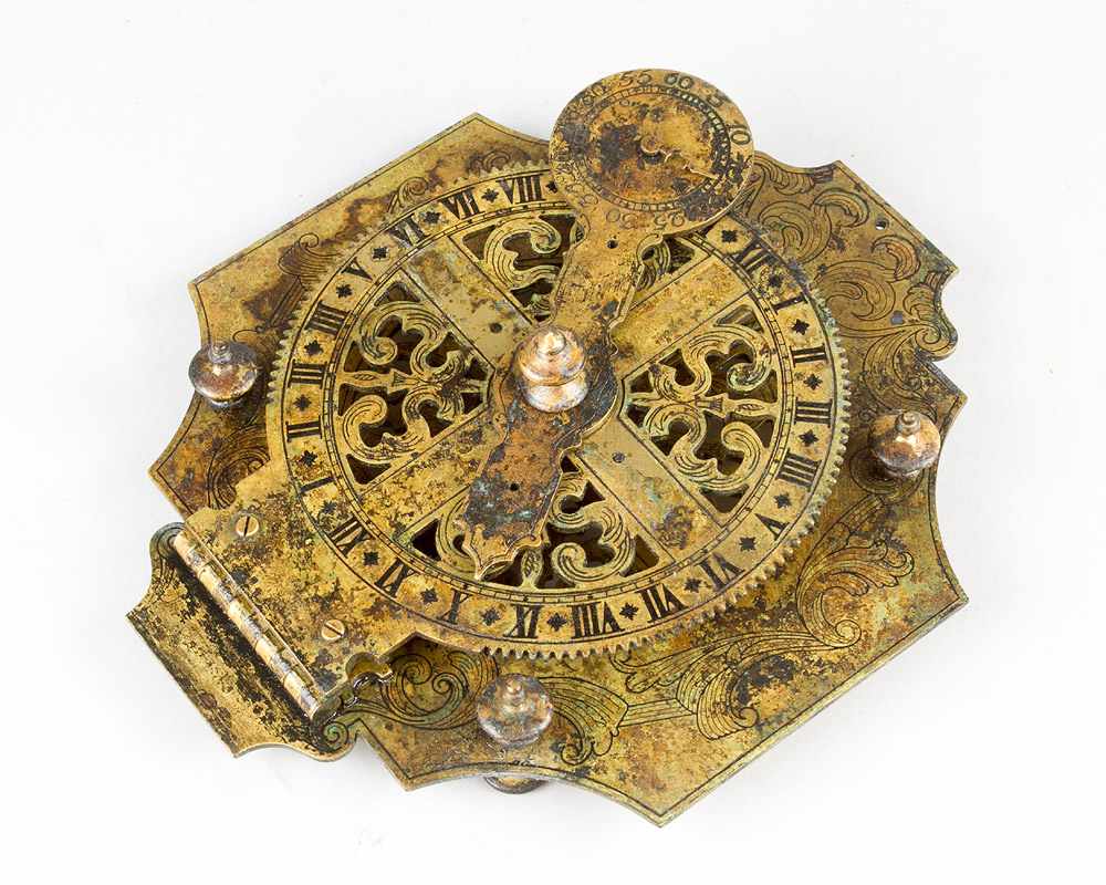 A large bronze sundial with open work scale and engraved decorations; Arabic and Roman numbers,